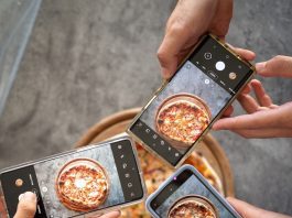 person holding black smartphone taking photo of pizza