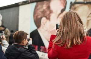 Политиката и менувањето на општеството a woman taking a picture of a man with a camera