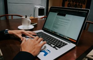 Вештачката интелигенција го менува безбедносниот пејсаж: Како да се заштитите во 2025 година a person using a laptop on a wooden table